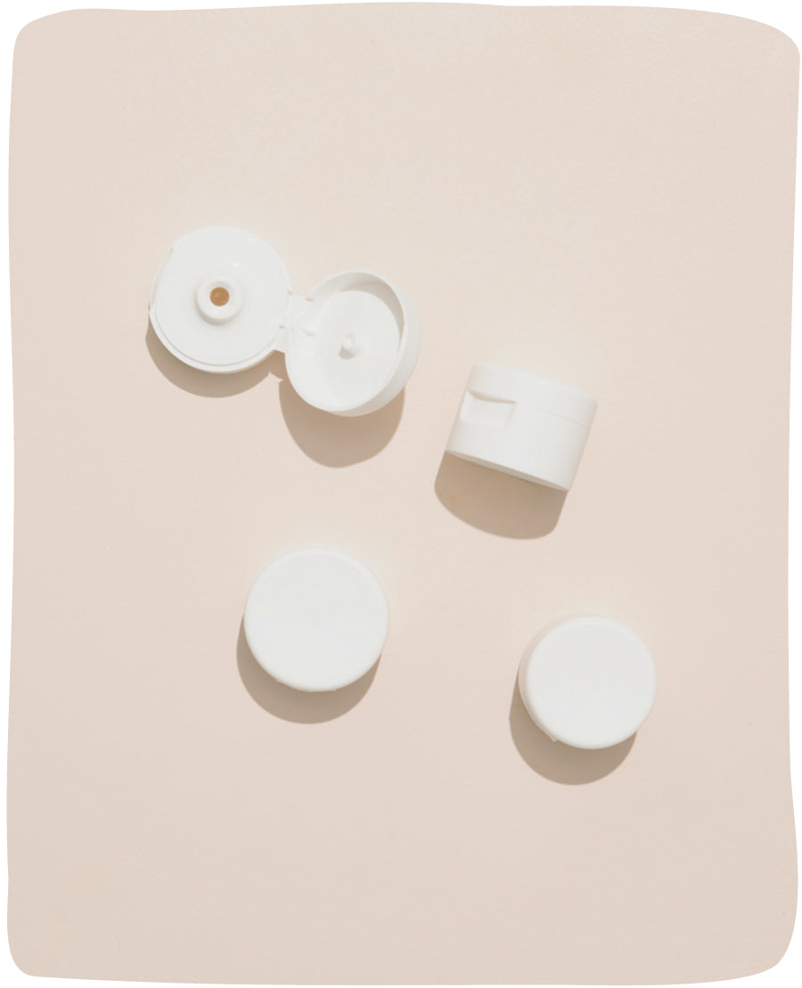 My Skin Feels plastic caps on a cream background